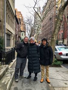 A group of people posing for a photo on a sidewalk  Description automatically generated with low confidence